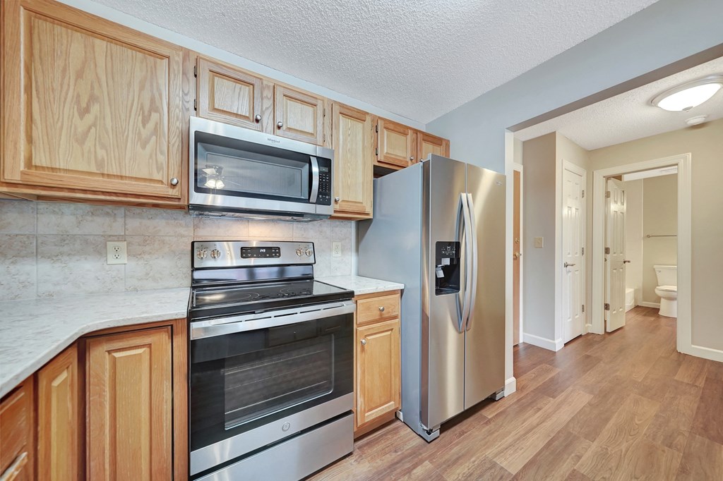 a kitchen with stainless steel appliances and wooden cabinets