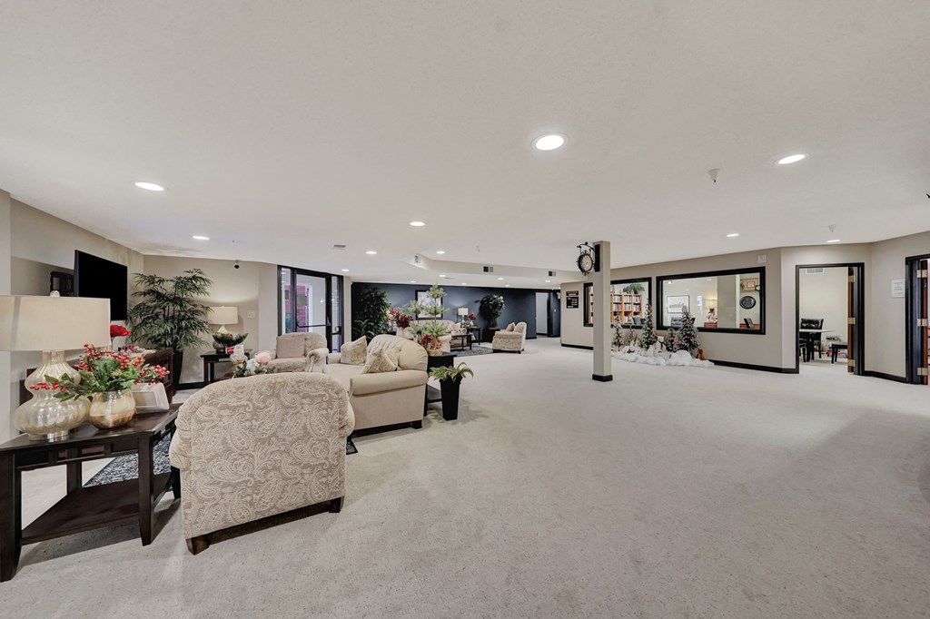 a large living room filled with furniture and large windows