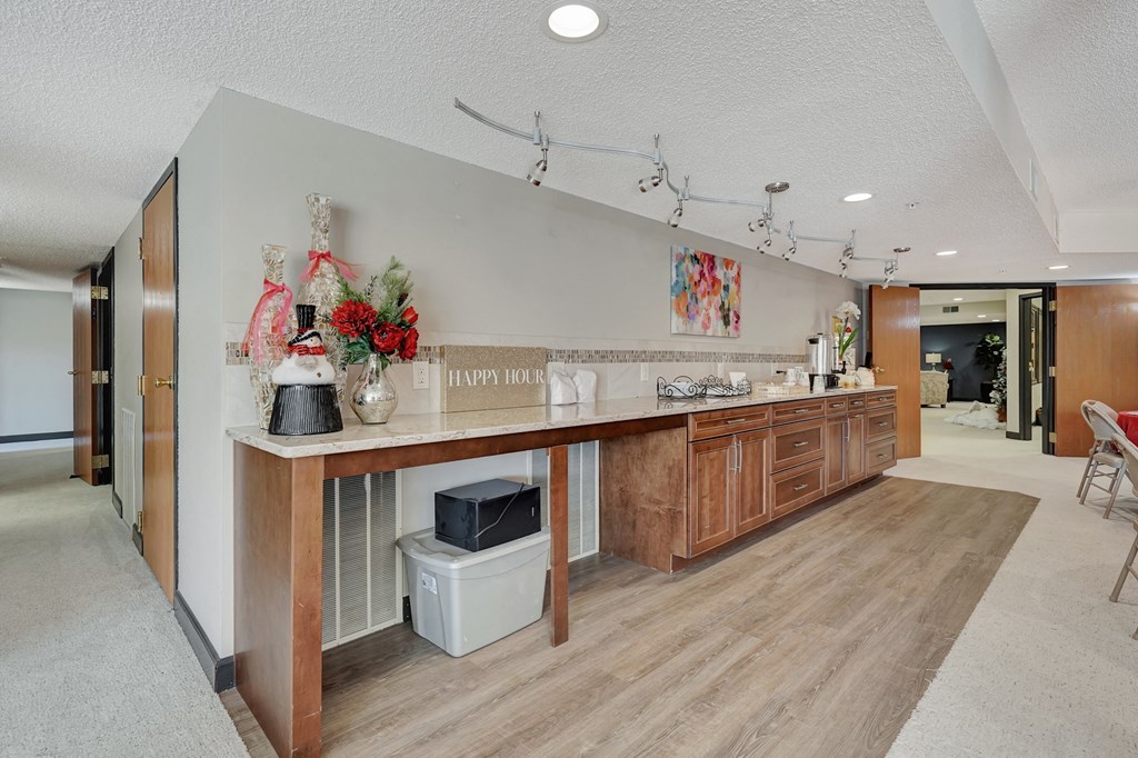a long kitchen with a wooden counter top in a house