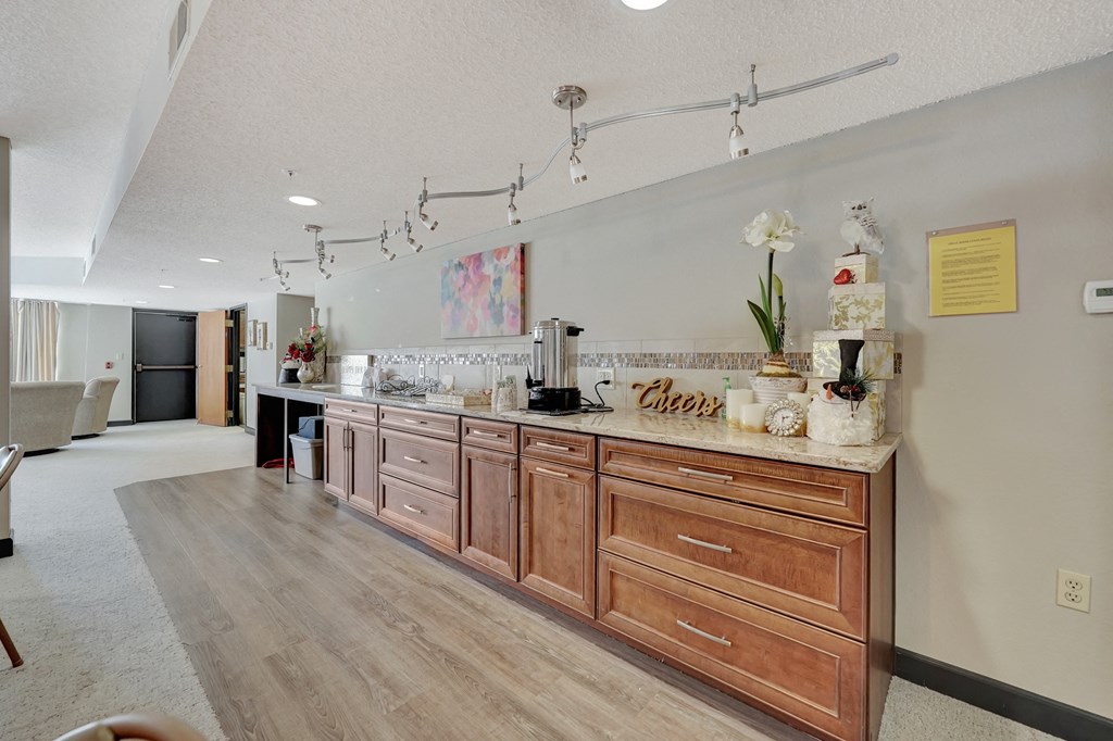 a kitchen with wood cabinets and a counter top with a sink