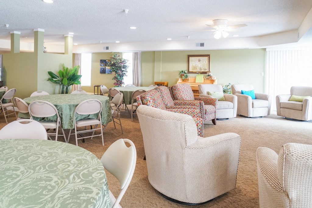 a living room and dining room with chairs and tables