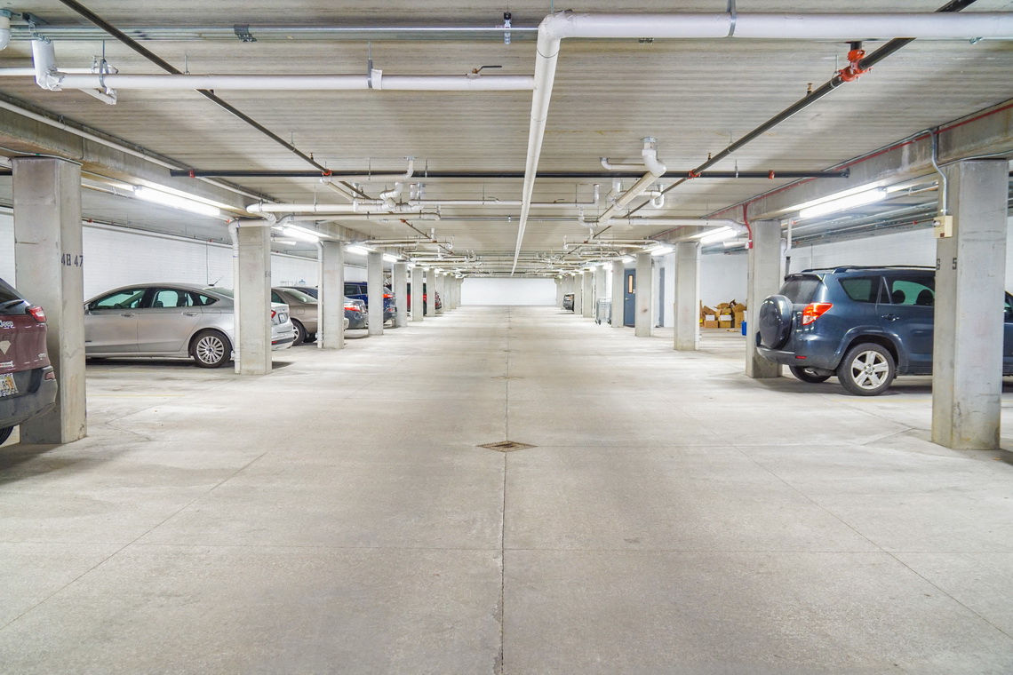 an empty parking garage with cars parked in it