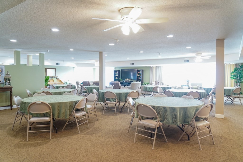 a dining room with tables and chairs and a ceiling fan