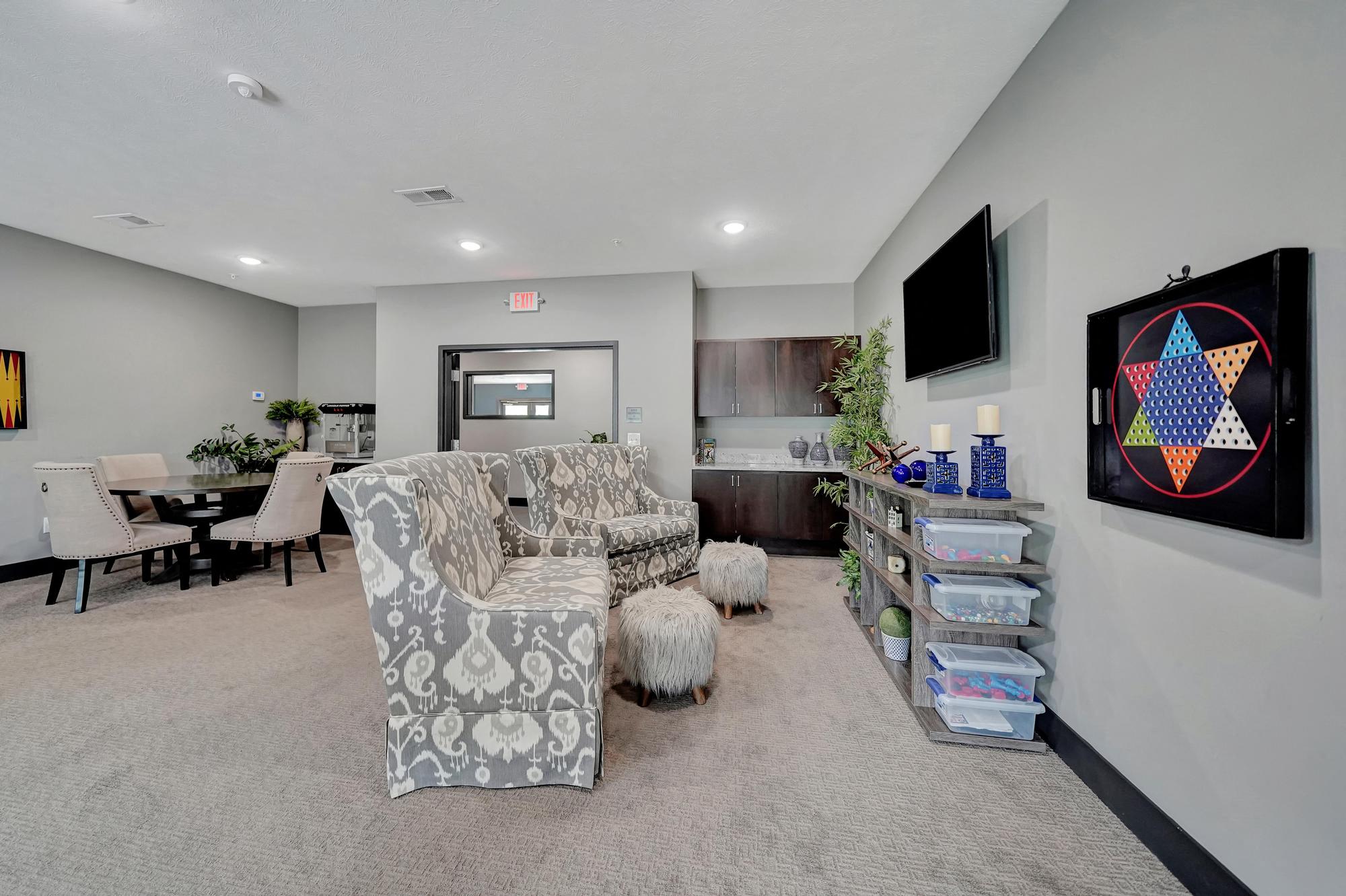 A living room with a grey carpet and a white sofa.