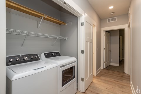 Laundry closet with side by side washer and dryer at Water's Edge at the Woodlands Apartments, Lincoln, NE