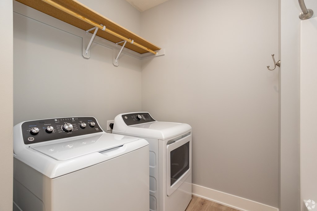 A small laundry room with a washer and dryer.