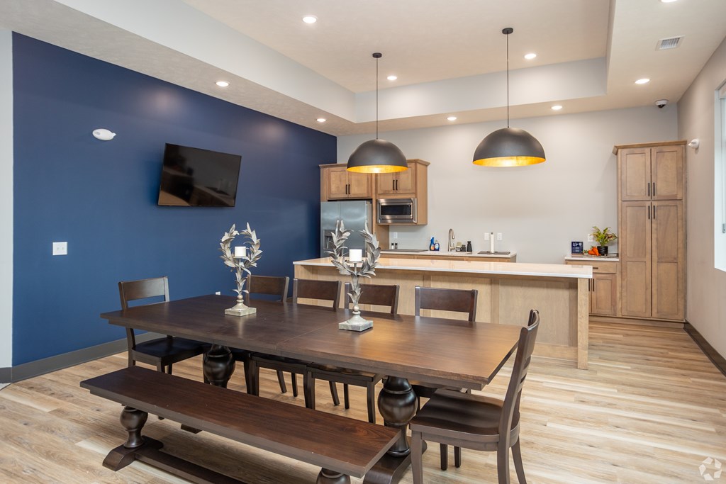 A modern dining room with a wooden table and chairs.