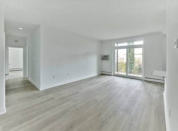 Spacious living room leading to private balcony - Photo Gallery 6