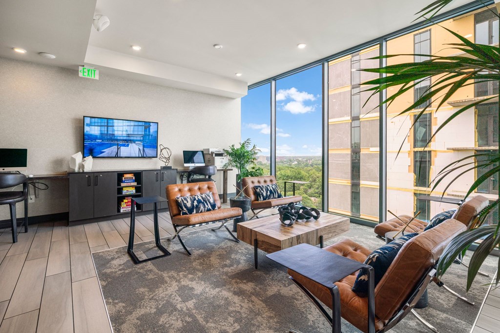 a living room with couches and chairs and a television