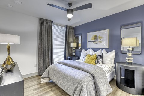 a bedroom with a bed and a ceiling fan