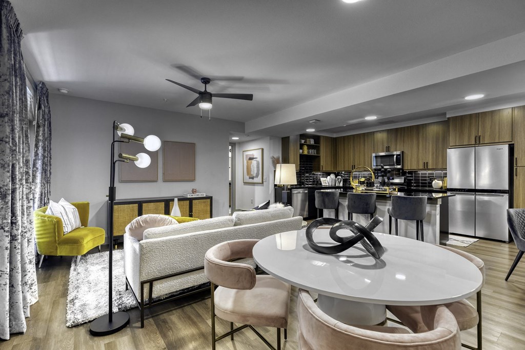 a living room and kitchen with a table and chairs
