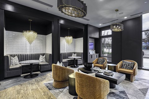 a lounge area with chairs and tables and chandeliers