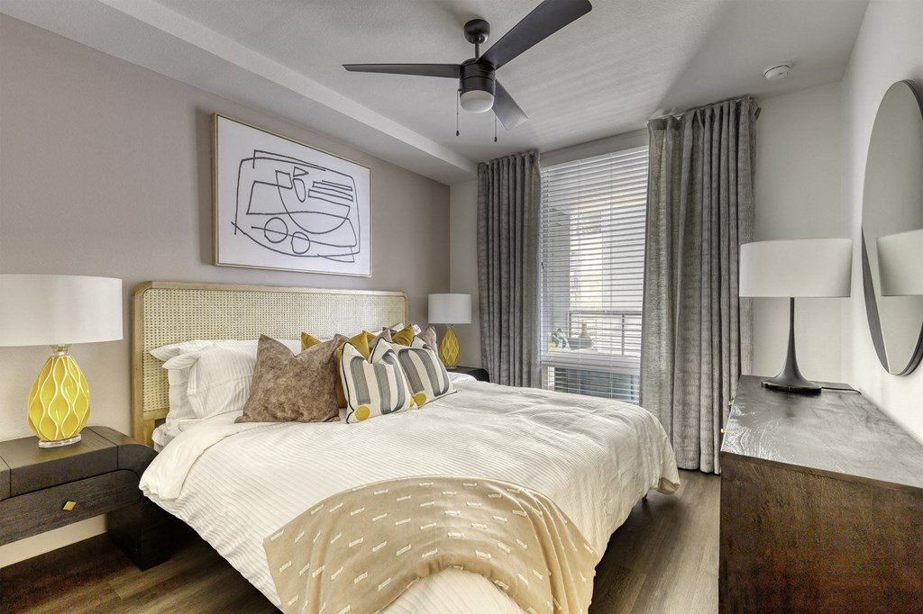 a bedroom with a large bed and a ceiling fan