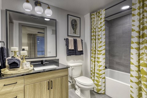 a bathroom with a toilet and a shower and a sink