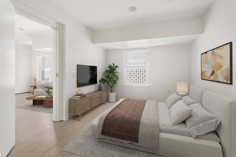 A bedroom with a large bed and a television.