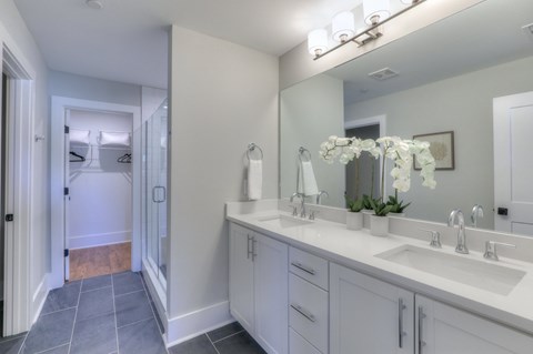 A bathroom with two sinks and a large mirror.