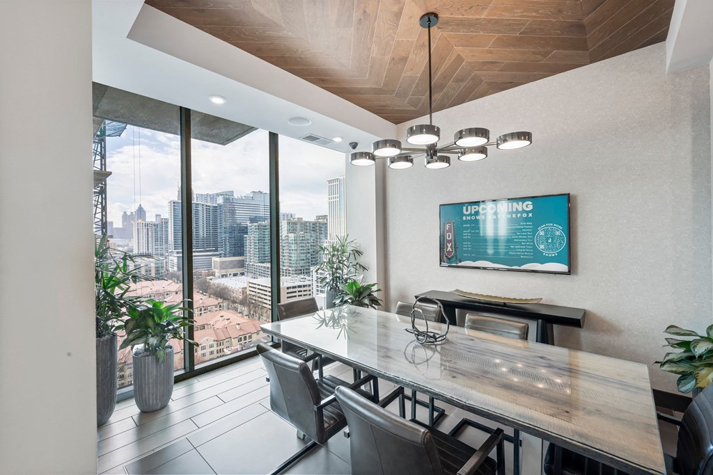 a conference room with a view of the city and a table and chairs
