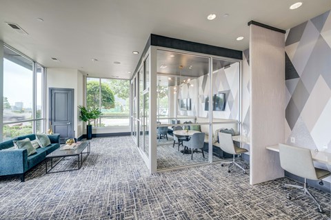 a conference room with glass walls and tables and chairs