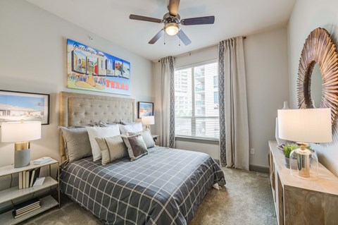 a bedroom with a large bed and a ceiling fan