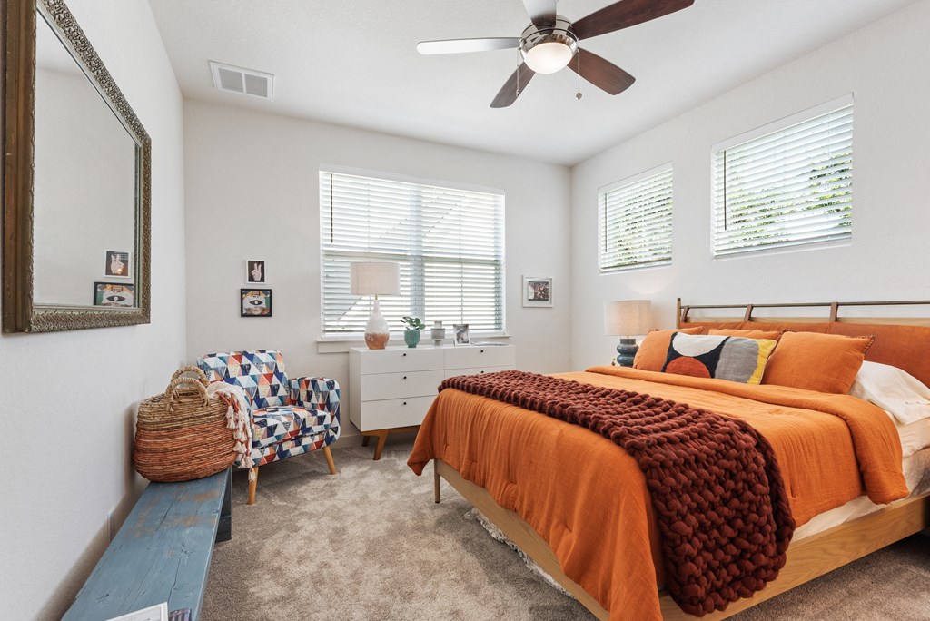 a bedroom with a bed and a ceiling fan
