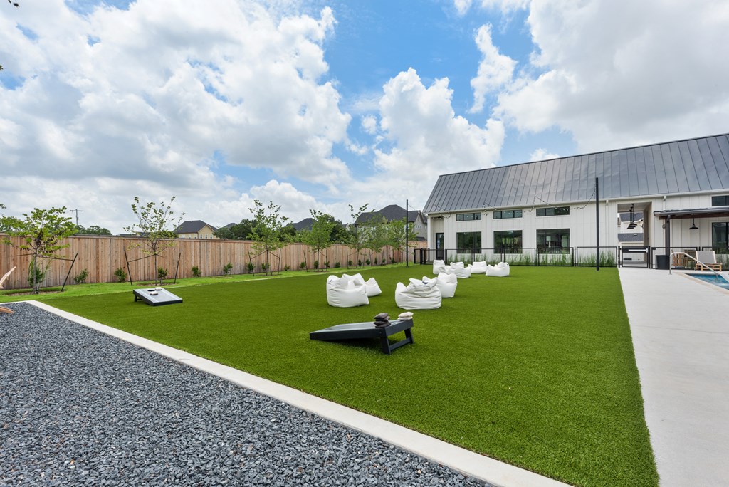 a yard with lawn furniture and a building in the background