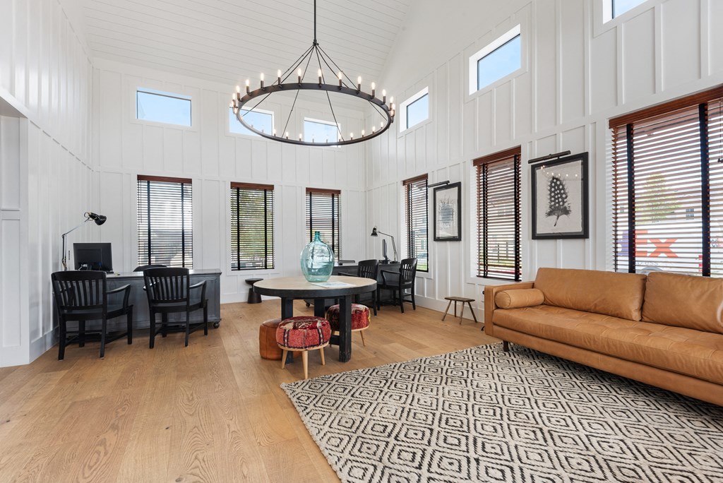a living room with a couch and a table and a chandelier