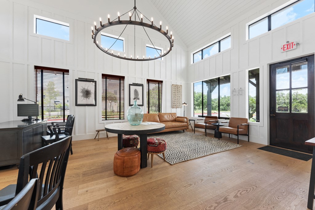 a large living room with a large circular chandelier and a dining room table