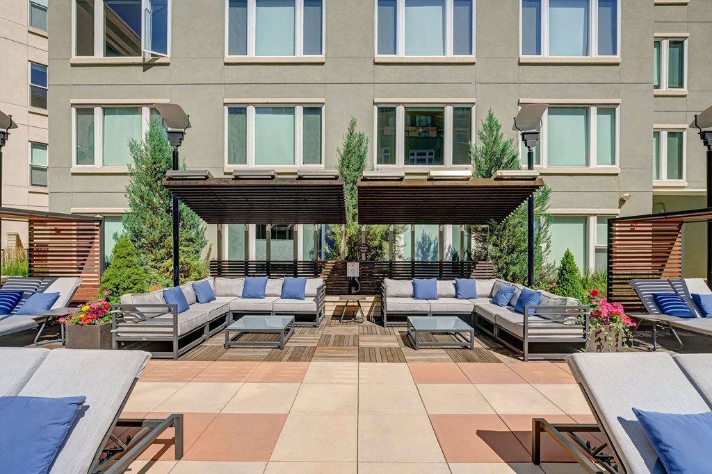 an outdoor lounge area with couches and chairs at ALARA Union Station Apartments in Denver, 80202