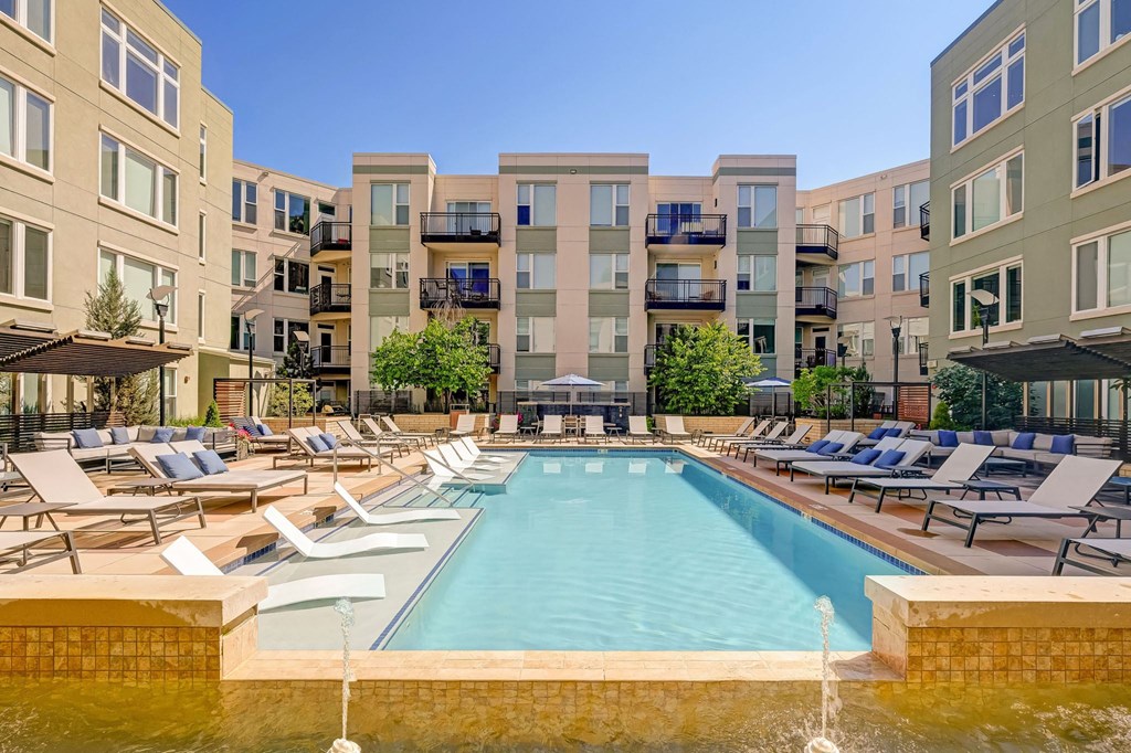 Swimming pool with lounge chairs at ALARA Union Station Apartments in Denver, 80202