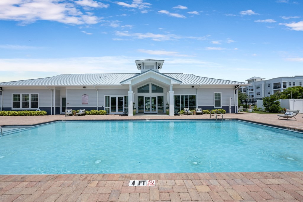 A large swimming pool in front of a building.