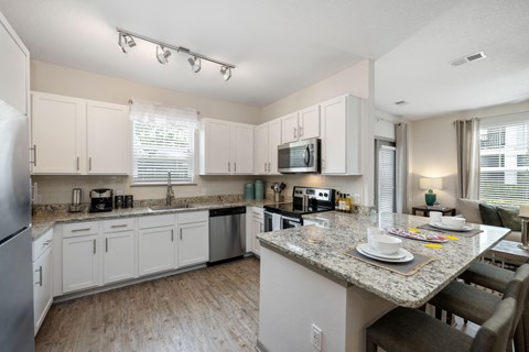 A kitchen with a table set for two.