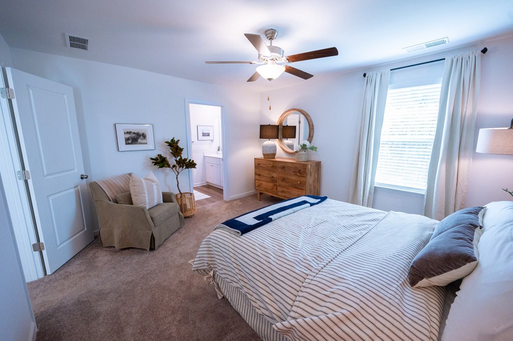 a bedroom with a large bed and a ceiling fan