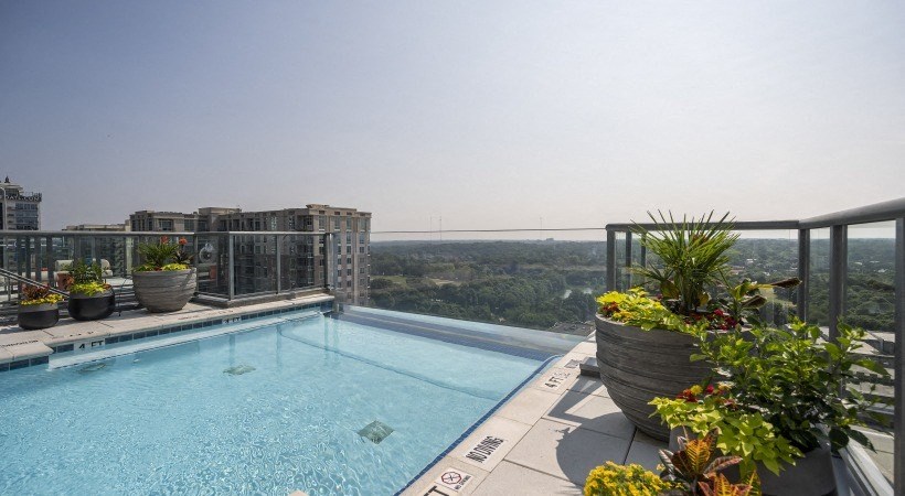 the pool on the roof of a building with a view of the city