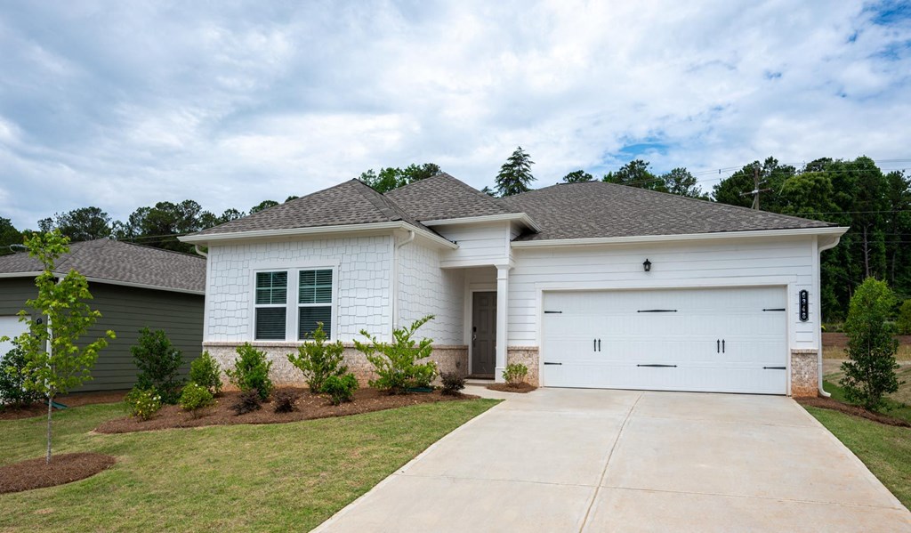 a home with white siding and a white garage door