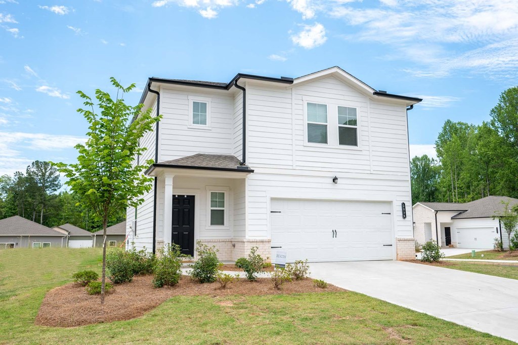 a home with white siding and a black door