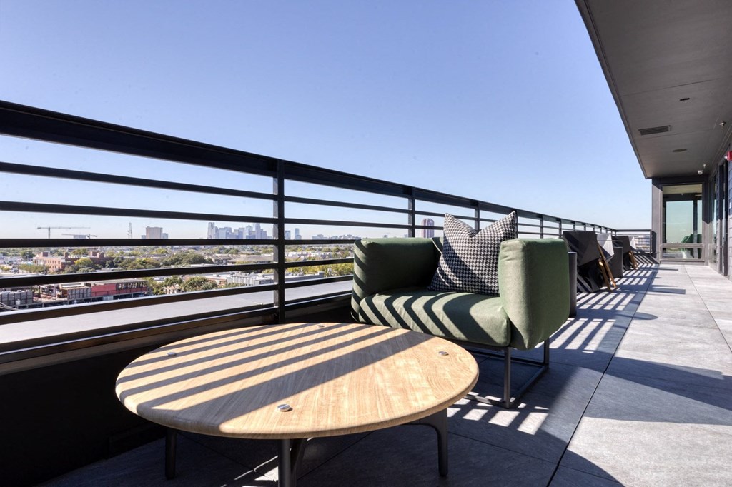 a patio with chairs and a table on a balcony