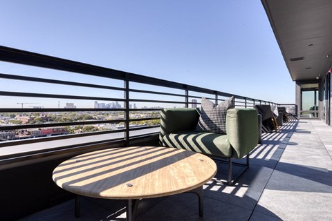 a patio with chairs and a table on a balcony