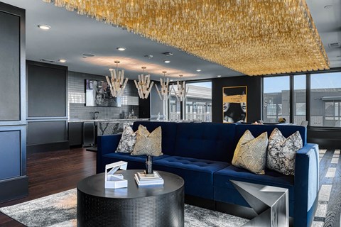 a living room with a blue couch and a table