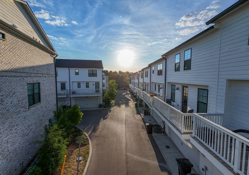 Sun sets over a street between rows of houses at 780 Townhomes, Franklin, TN, 37064