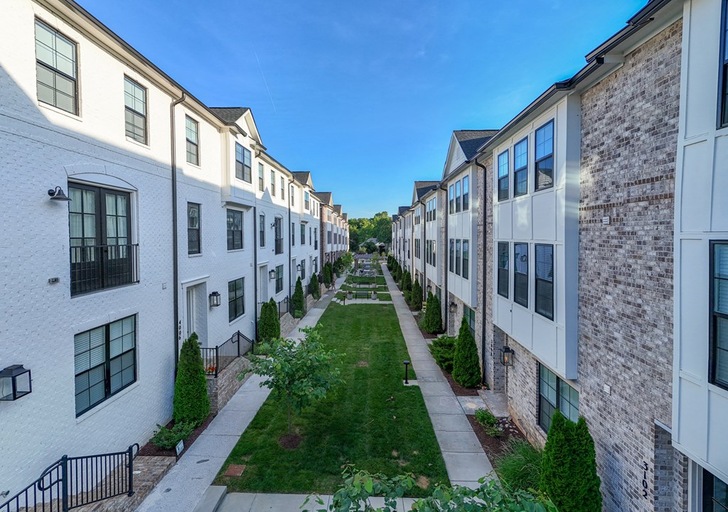 Alleyway between rows of white and brick apartment buildings at 780 Townhomes, Franklin