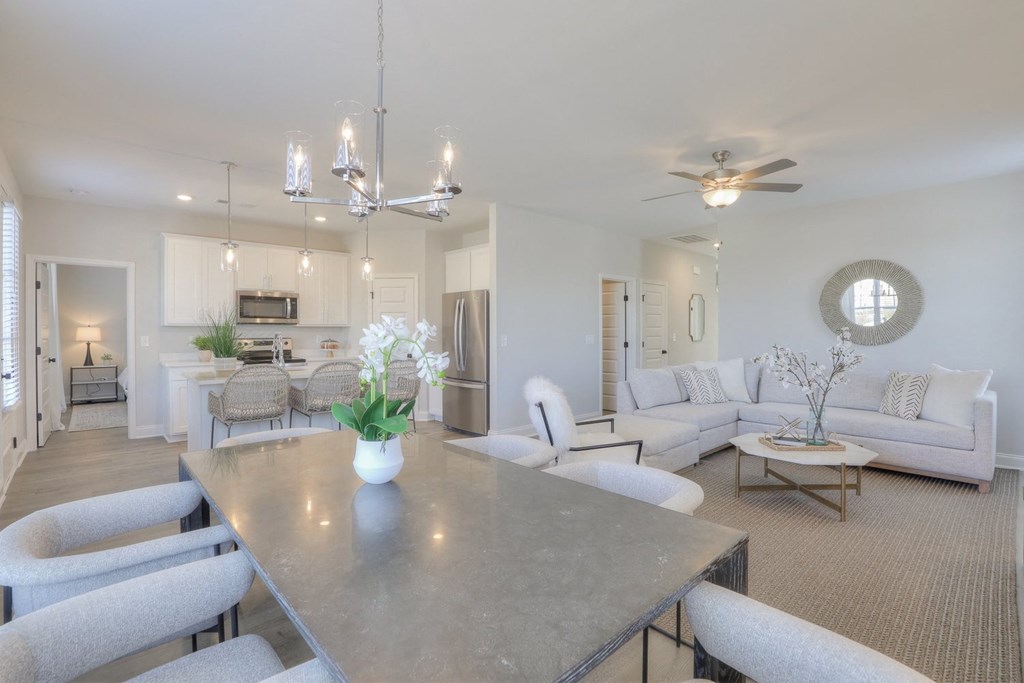 a living room with couches and a dining table