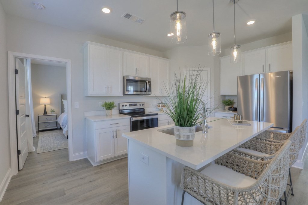 a kitchen with white cabinets and a counter top