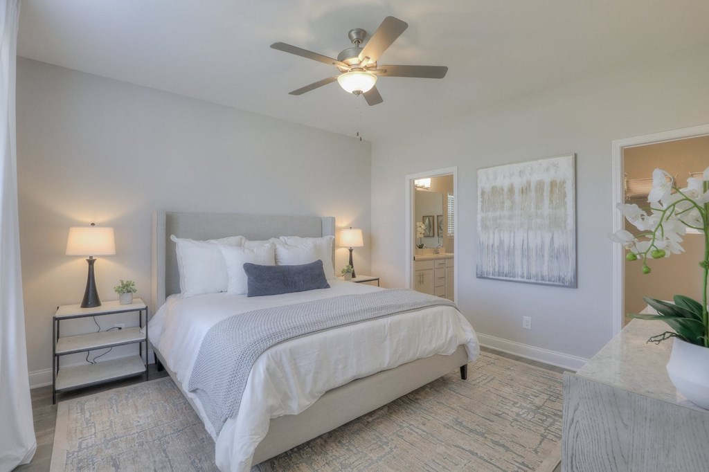 a bedroom with a bed and a ceiling fan