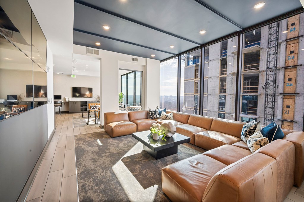 a living room with leather couches and a coffee table