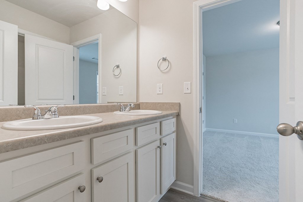 a bathroom with two sinks and a large mirror