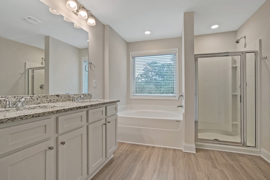 a large white bathroom with a shower and a sink