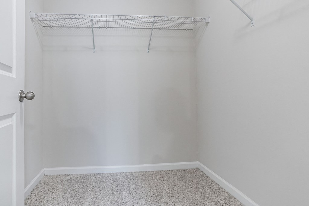 an empty closet in a home with white walls