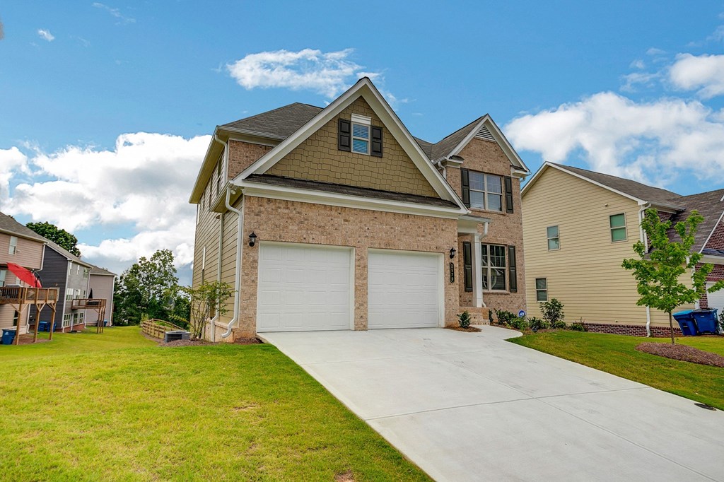 a house with a garage and a driveway in front of it