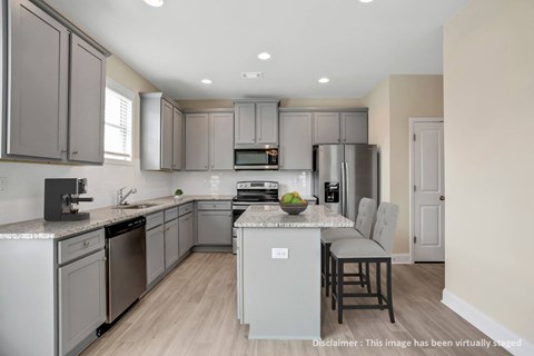 a kitchen with stainless steel appliances and gray cabinets
