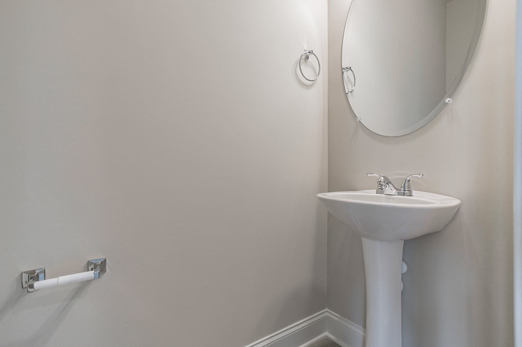 a small bathroom with a sink and a mirror